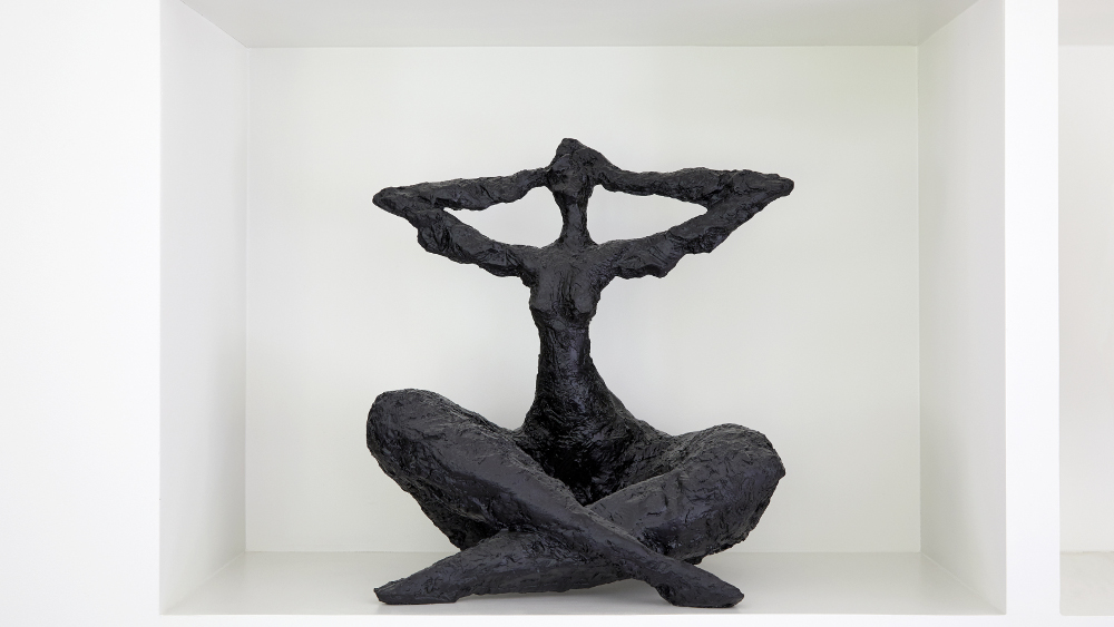Abstract black sculpture displayed within bespoke living room joinery shelving.