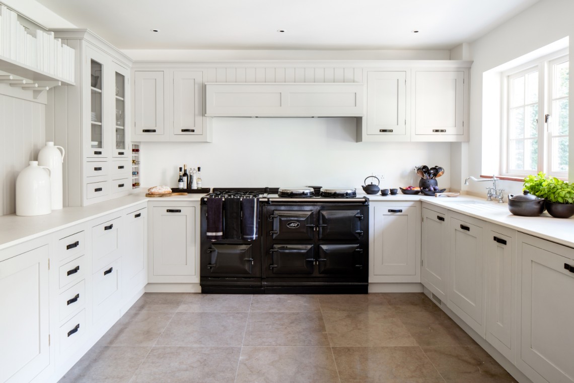 Bespoke Portland Stone Shaker kitchen with integrated cabinetry and a black range cooker, designed for a Buckinghamshire family home.