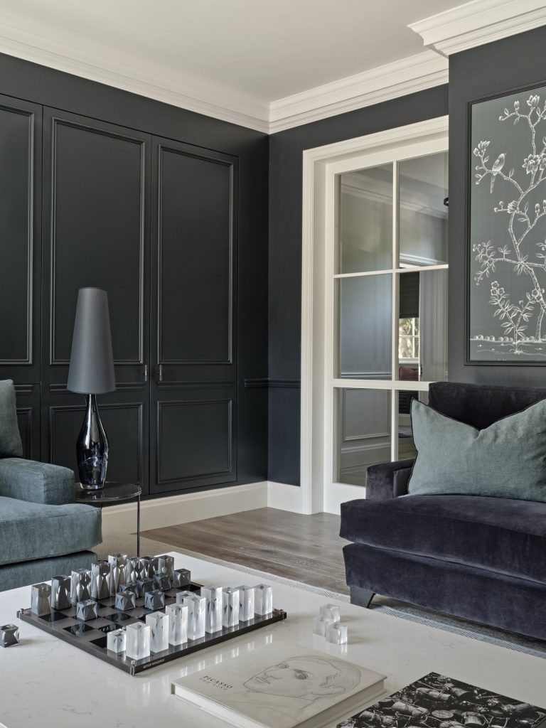 Surrey Residence sitting room with bespoke charcoal panelling, classic cornicing and contemporary furnishings.